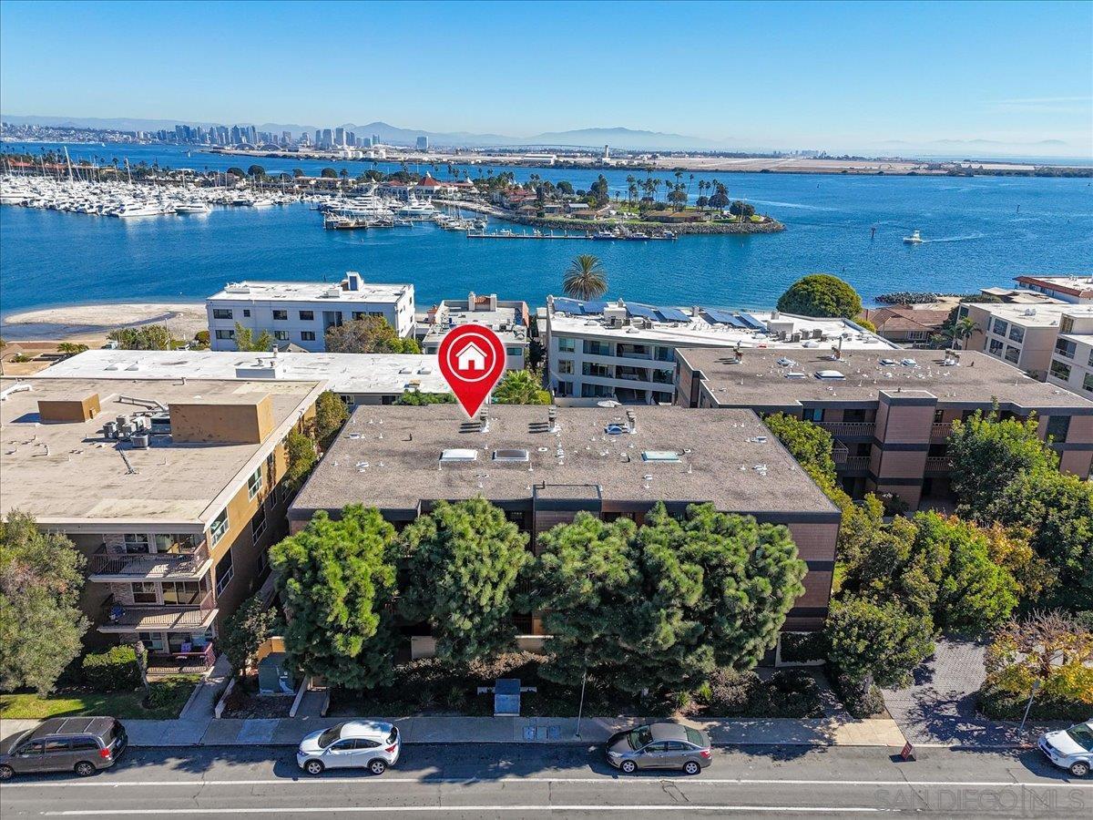 an aerial view of a houses with outdoor space and ocean view