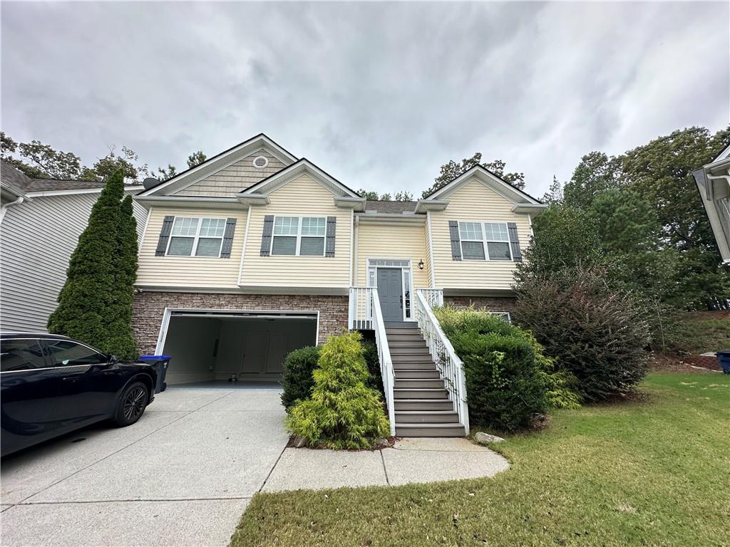 a front view of a house with a yard and garage