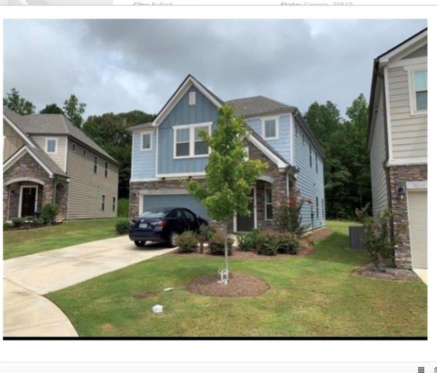 a front view of a house with a yard and garage