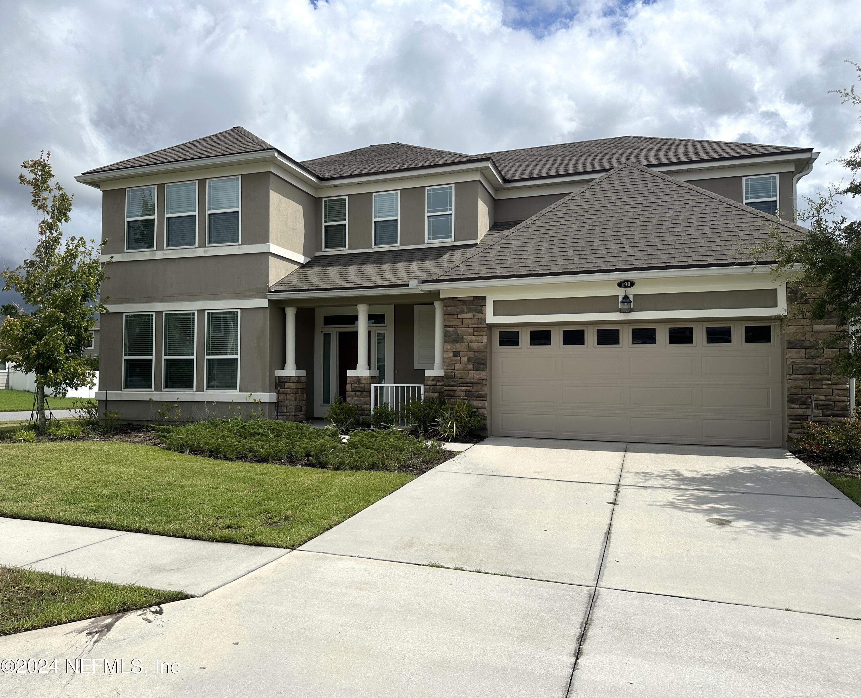 front view of a house with a yard