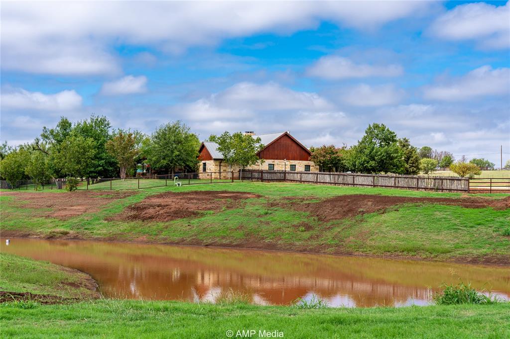 a view of green field with house in the background