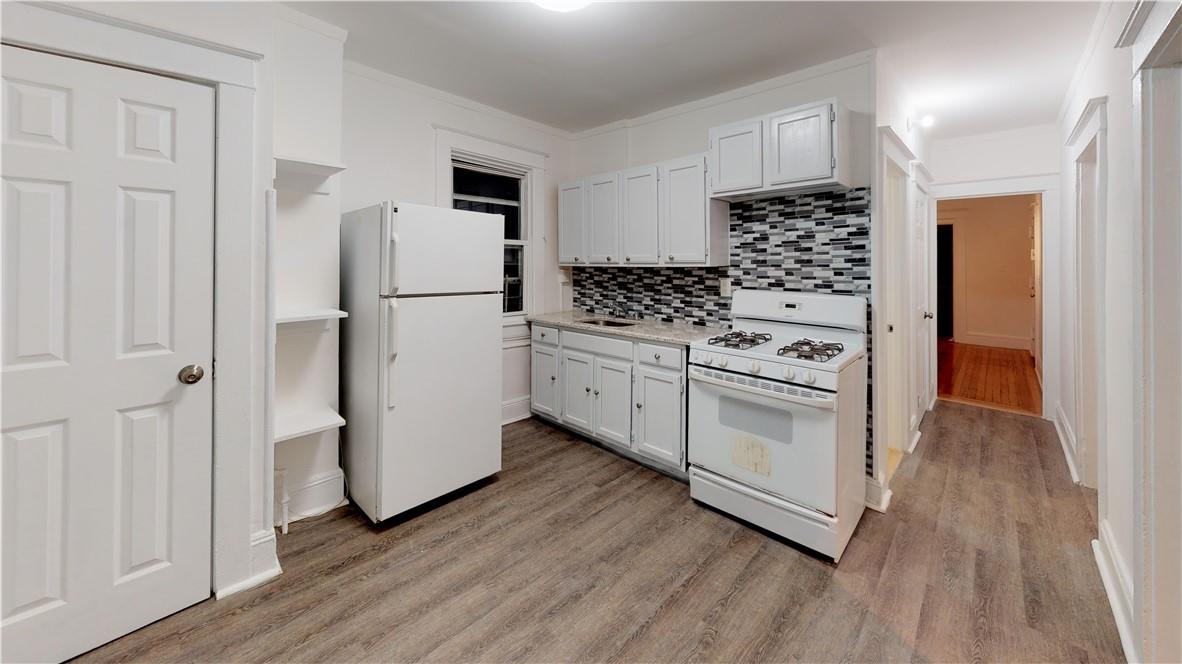 a kitchen with a stove a refrigerator and a stove top oven