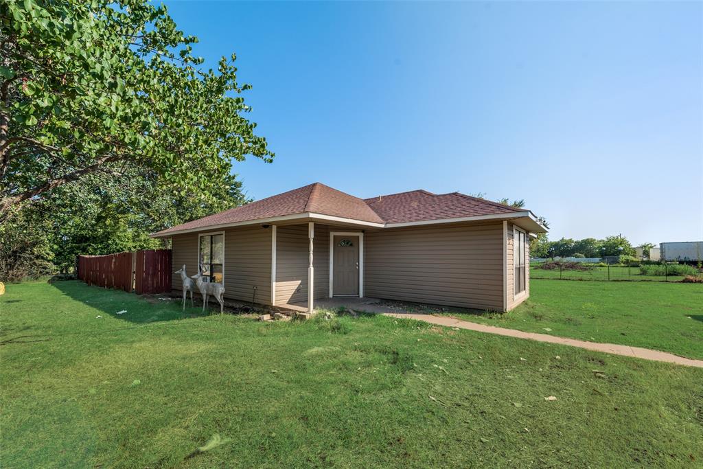 a front view of a house with yard and green space