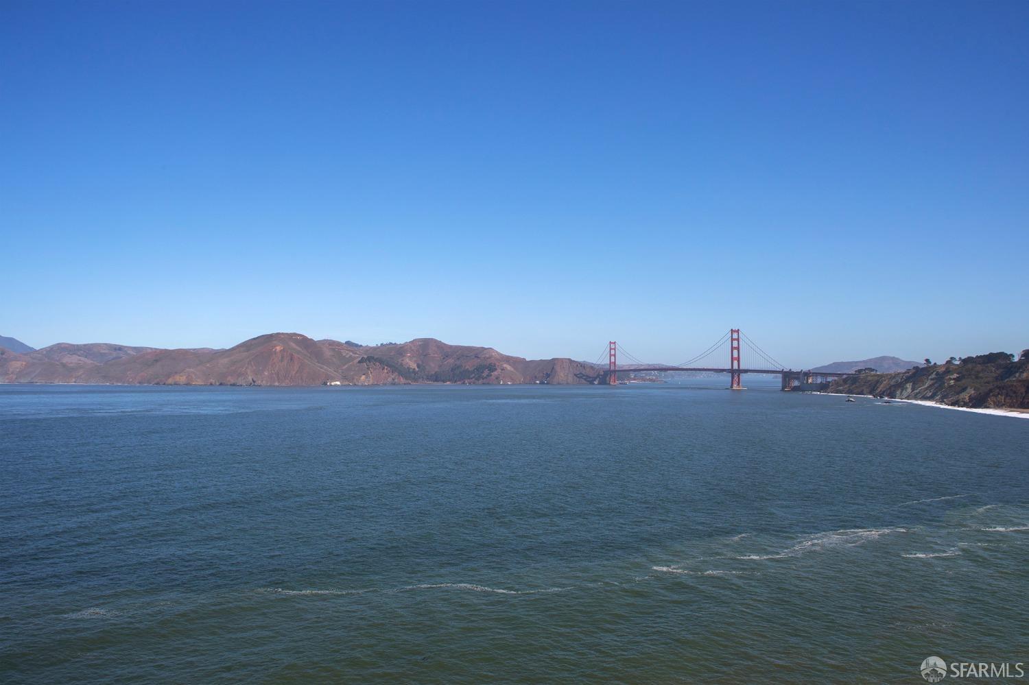 a view of an ocean with a mountain