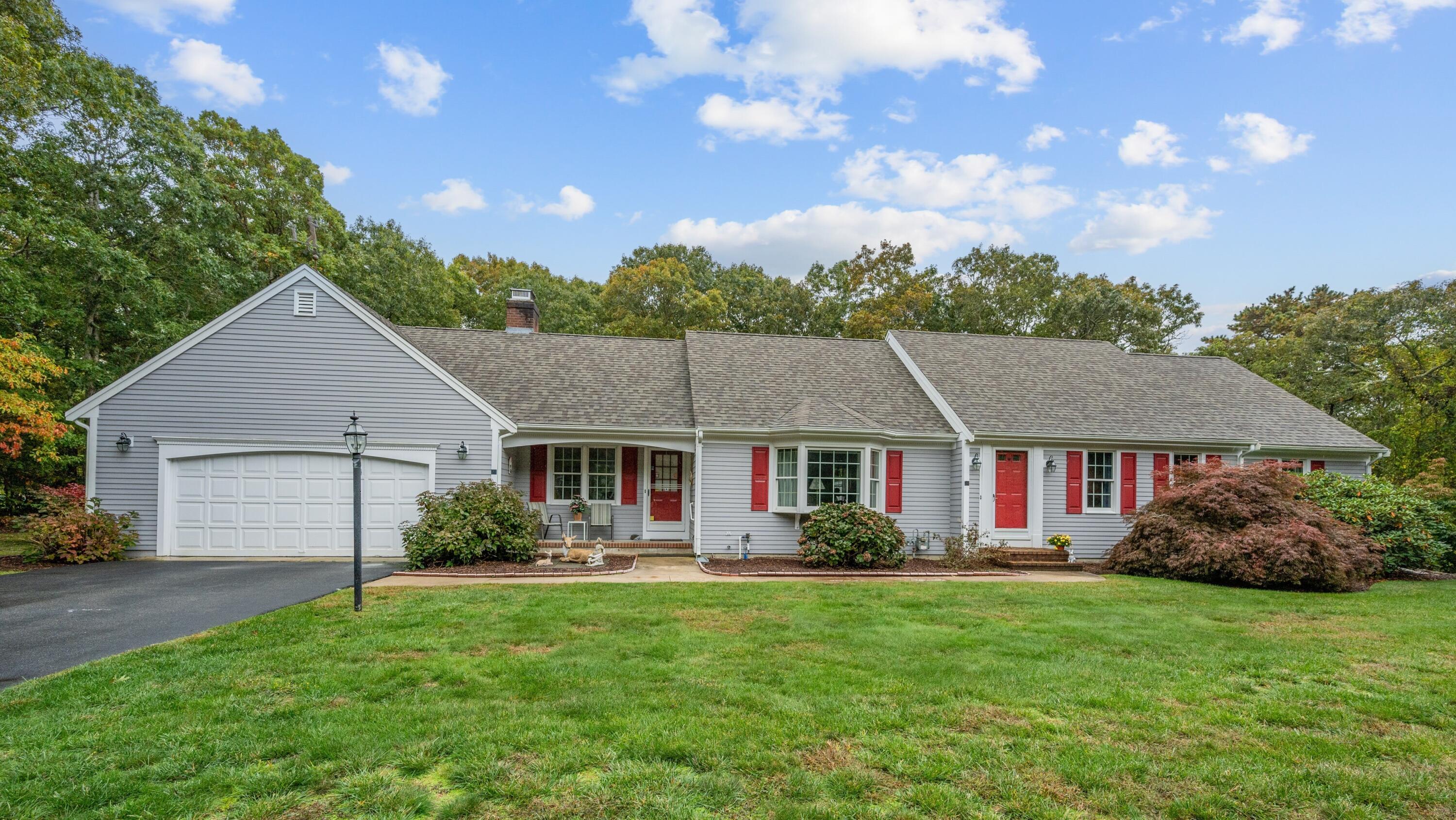 a front view of house with yard and green space