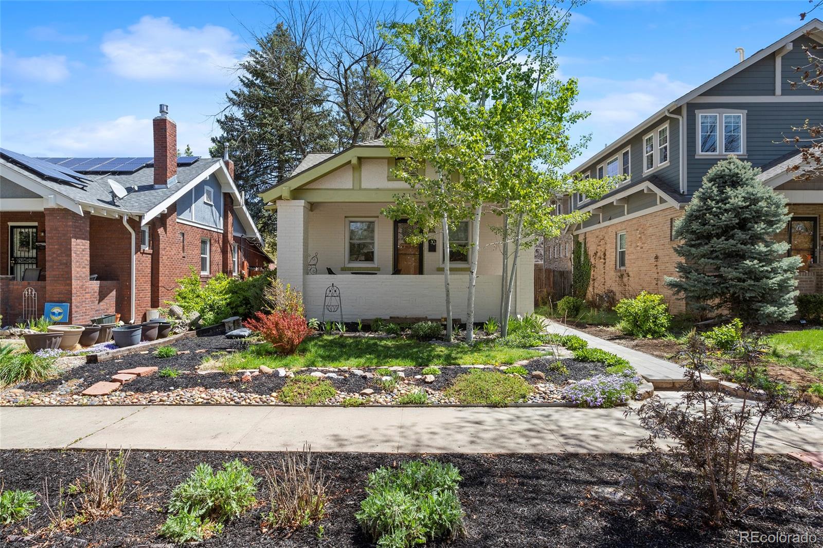 a front view of a house with garden