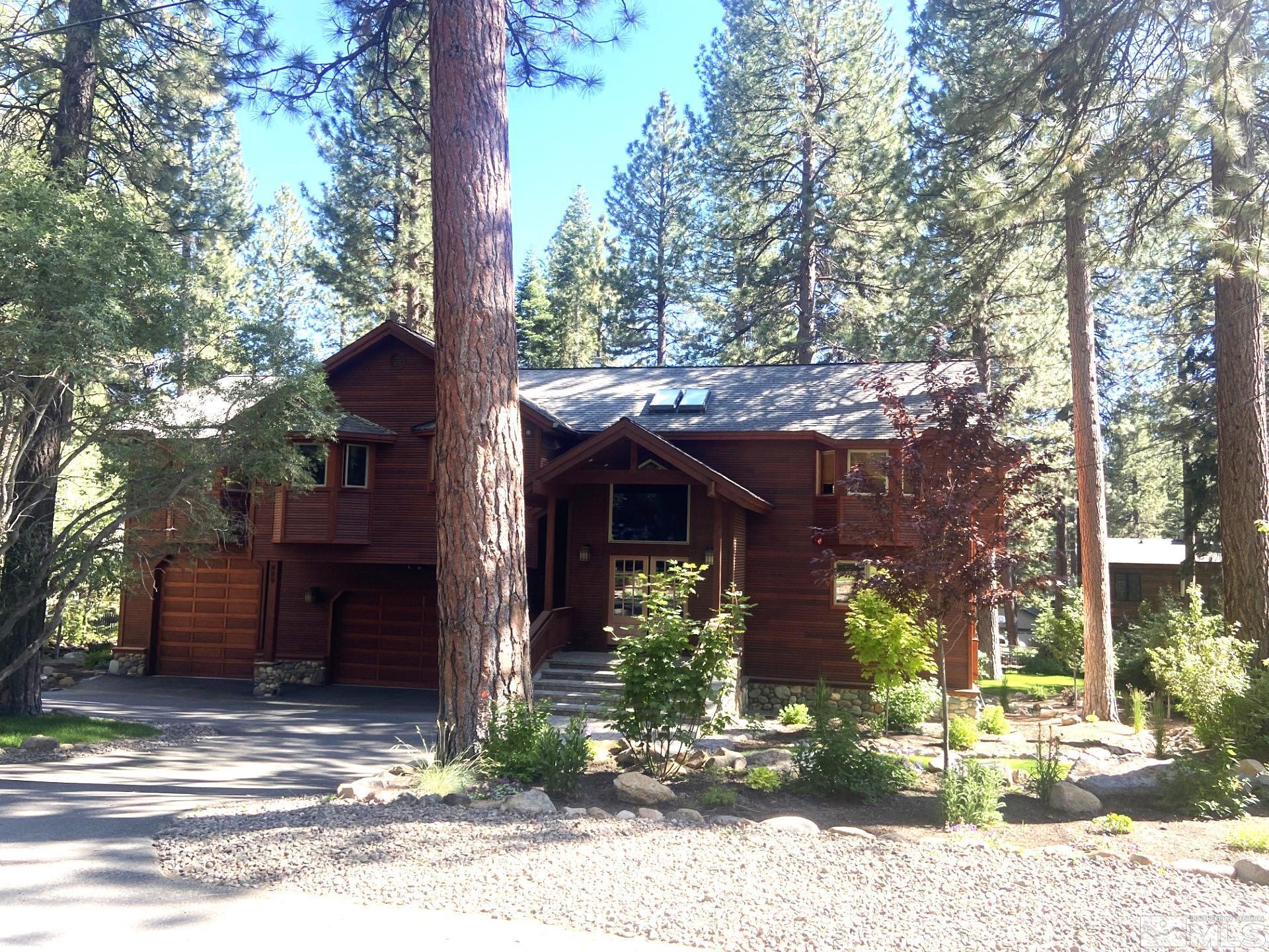 a view of a house with a tree front of house