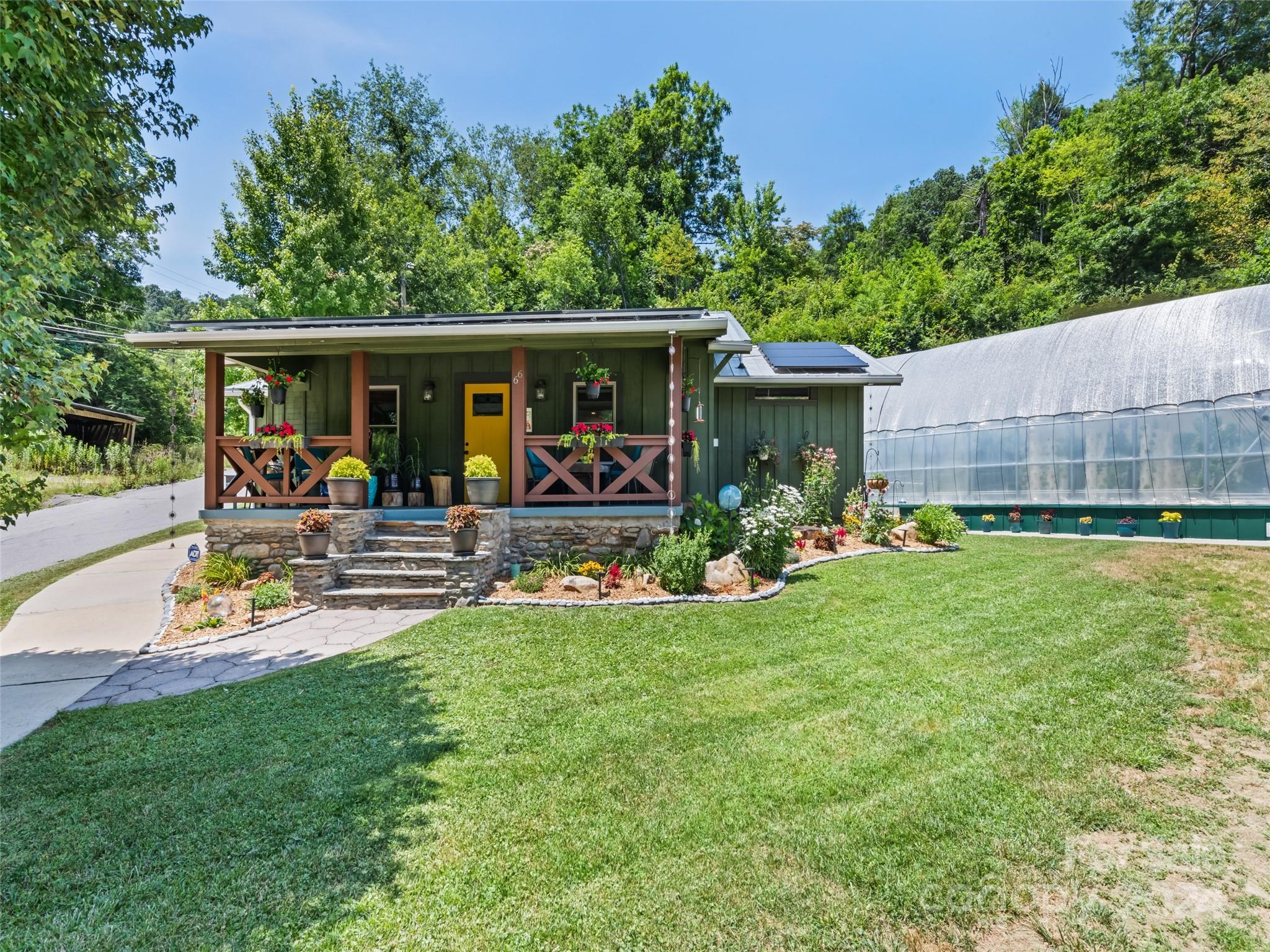 a view of a house with backyard and sitting area