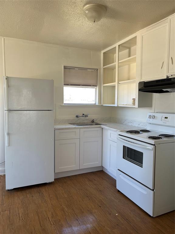 Neat & tidy kitchen with new lower cabinets & countertop.