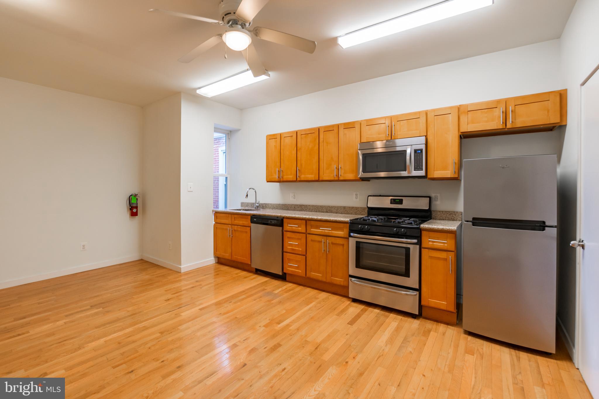 a kitchen with stainless steel appliances a stove a refrigerator and a sink