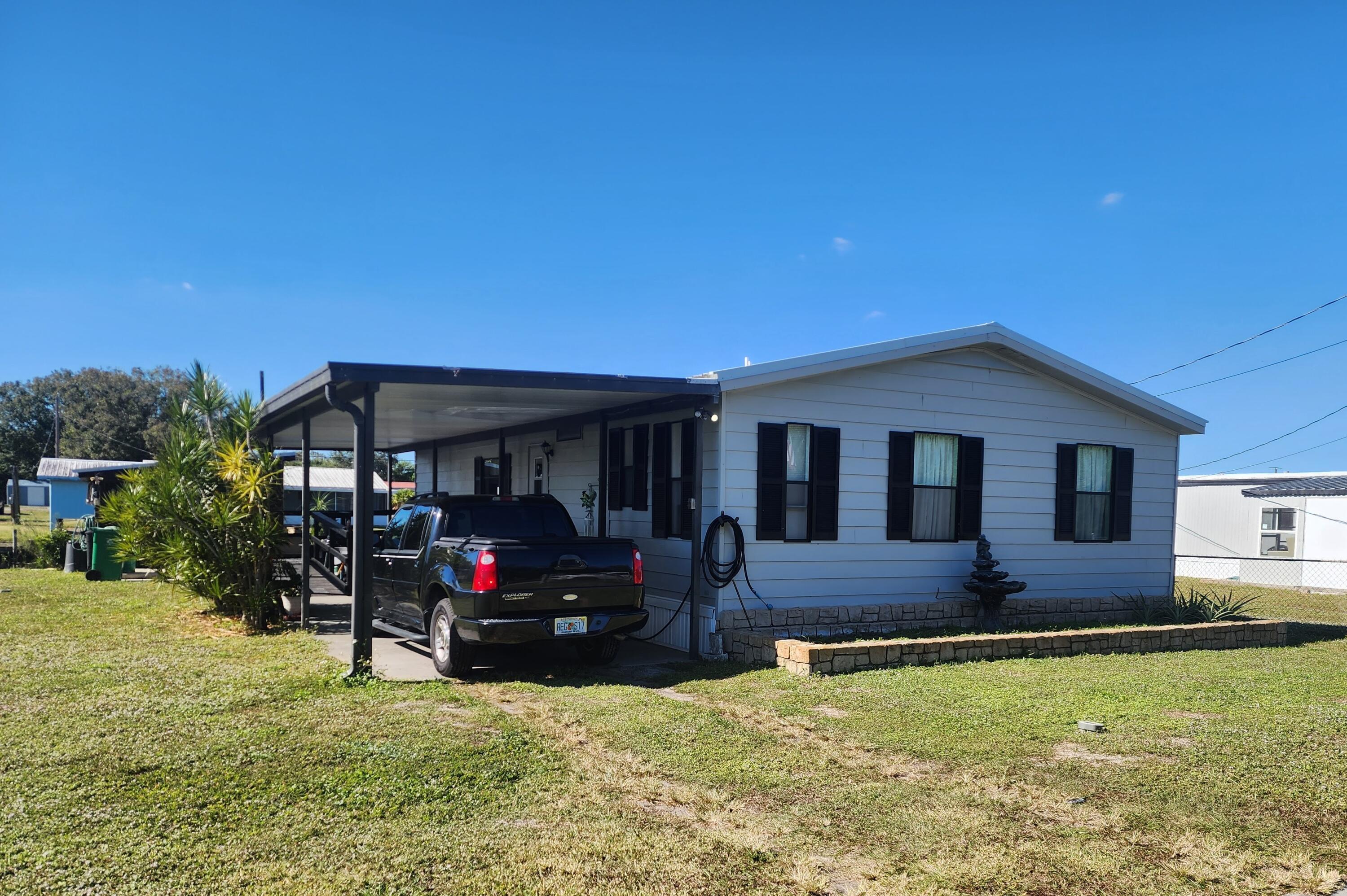 a front view of house with yard and outdoor seating