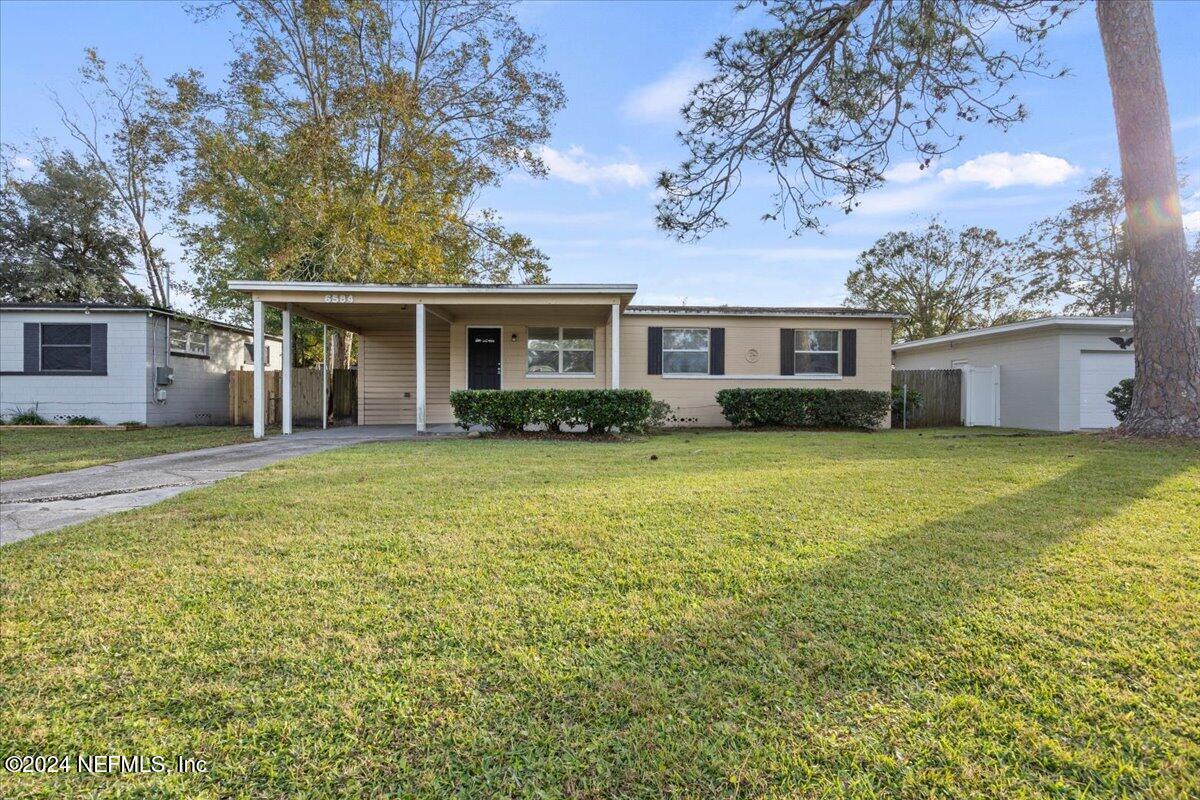 a front view of house with yard and green space