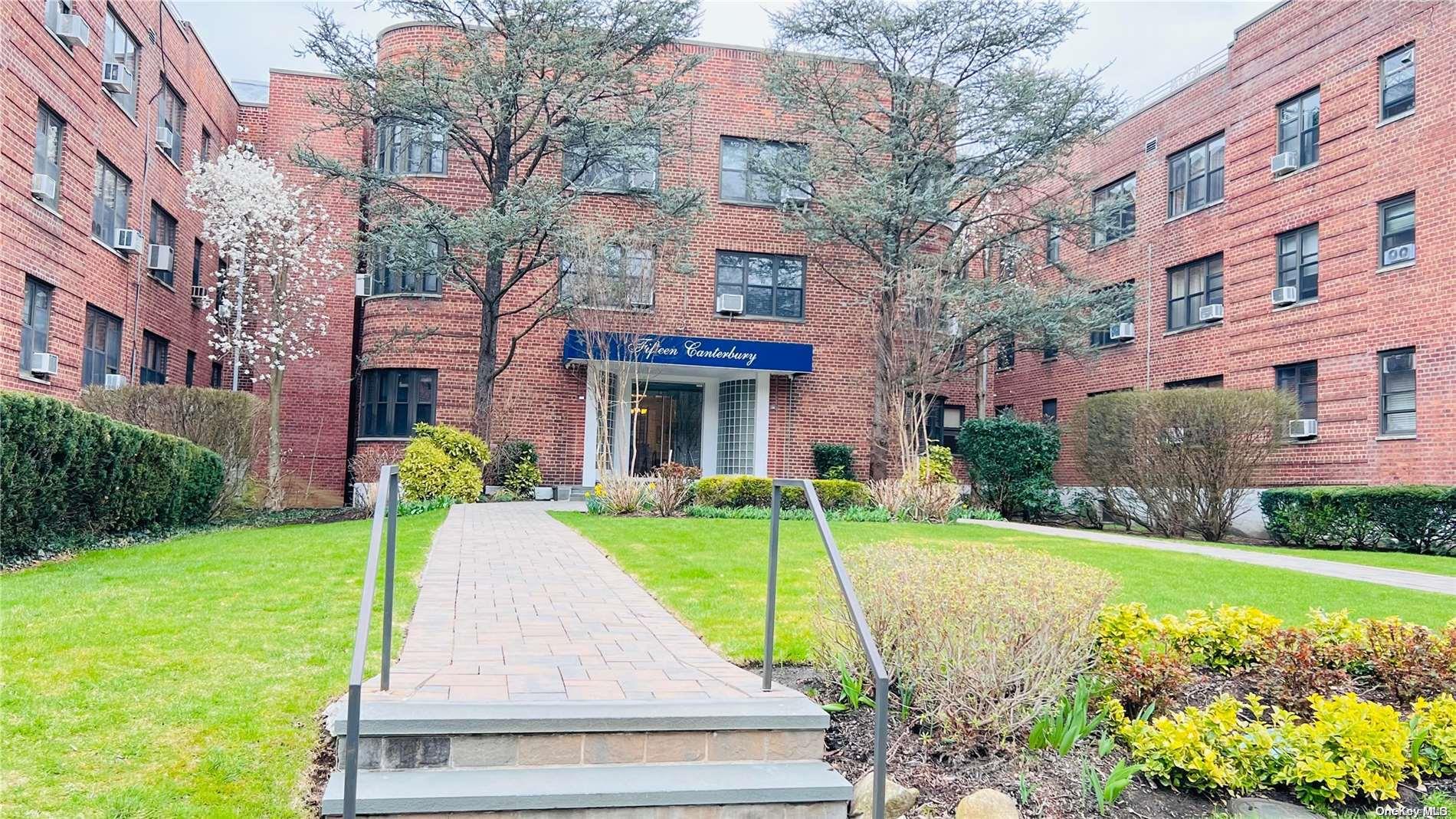 a front view of a building with garden