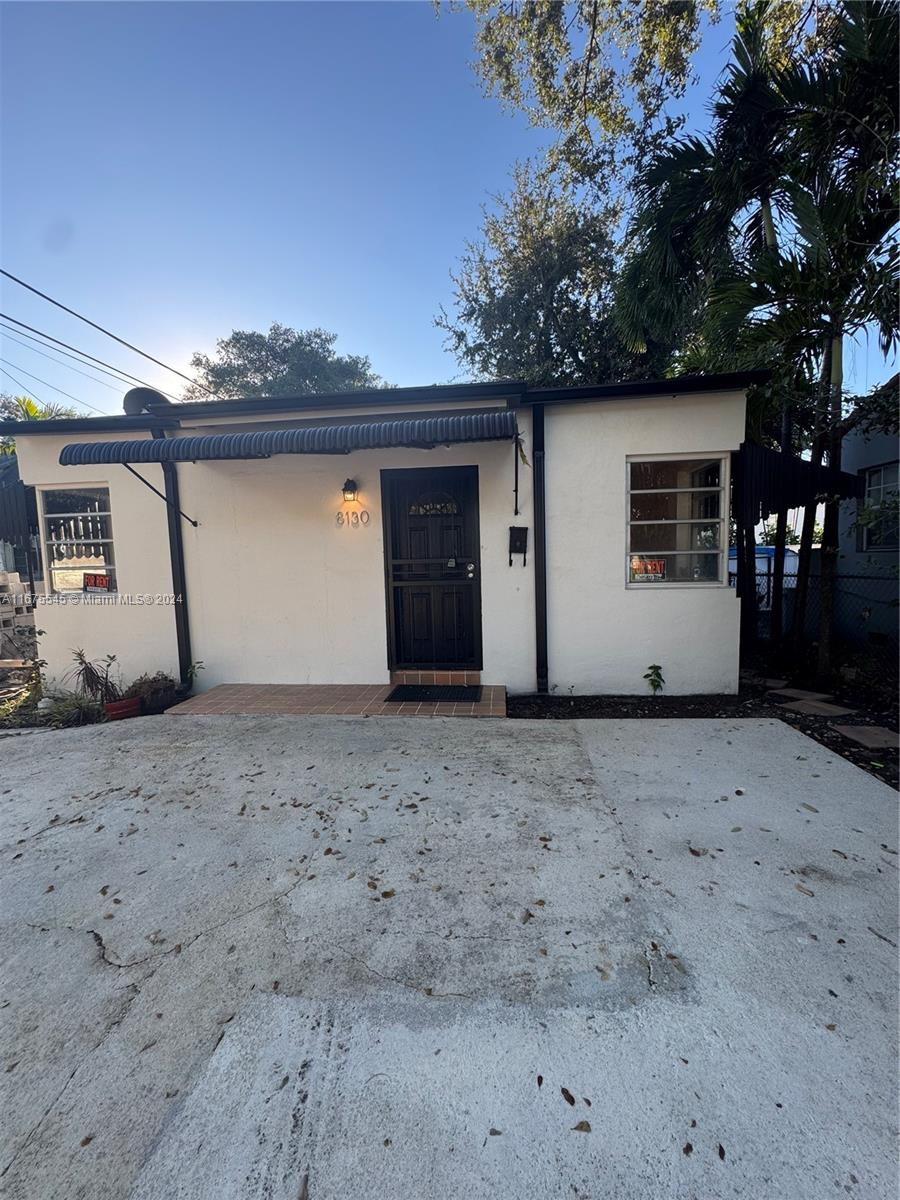 a view of a house with a dry yard and garage