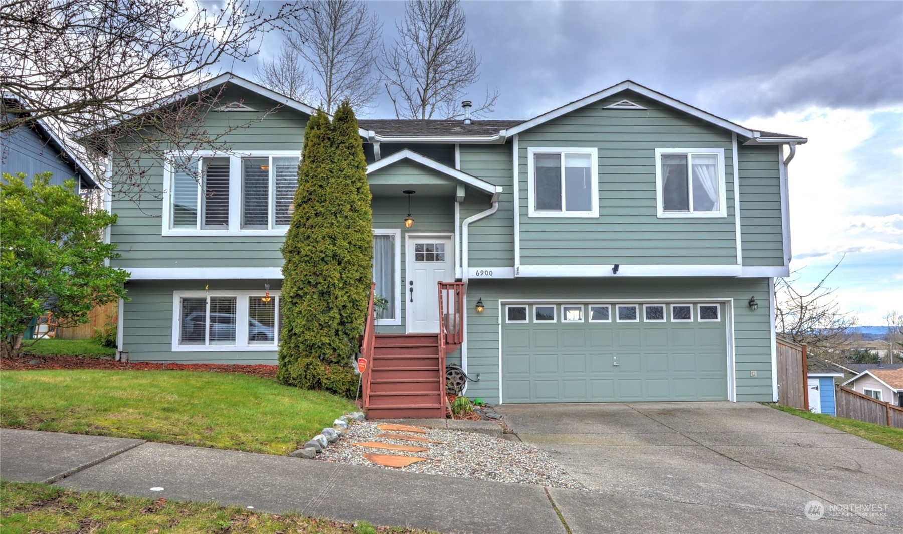 a front view of a house with a yard and garage