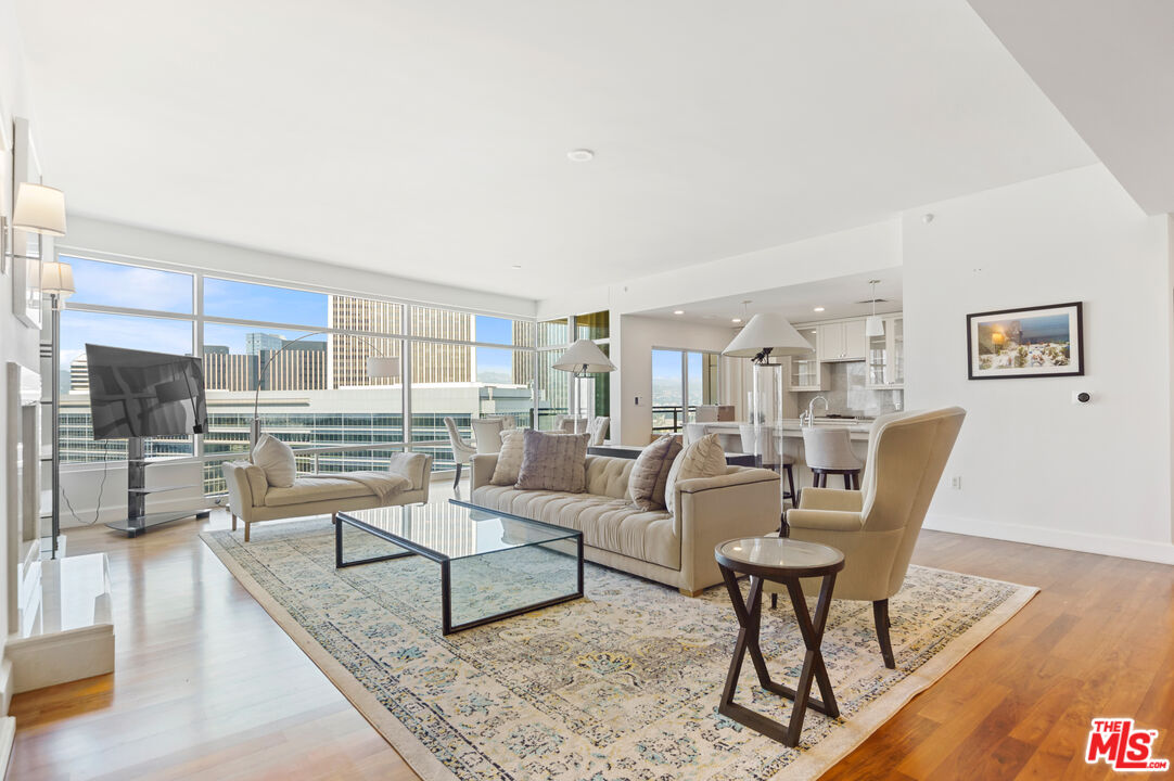 a living room with furniture a rug and a table