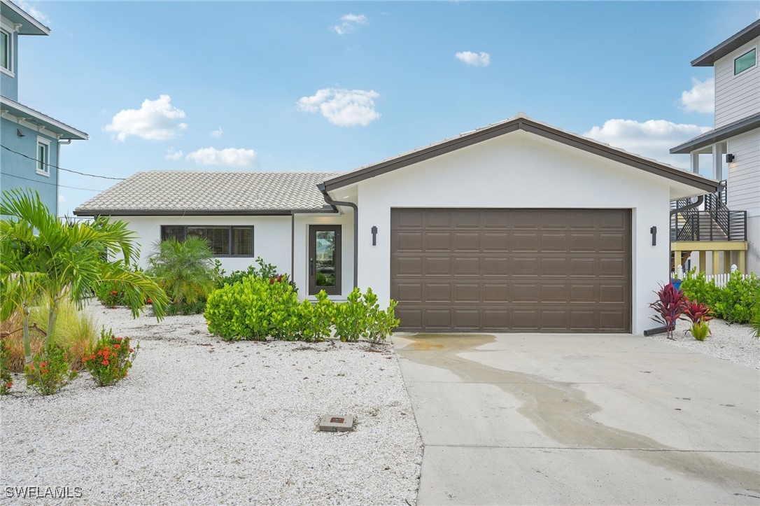 a front view of a house with a yard and a garage