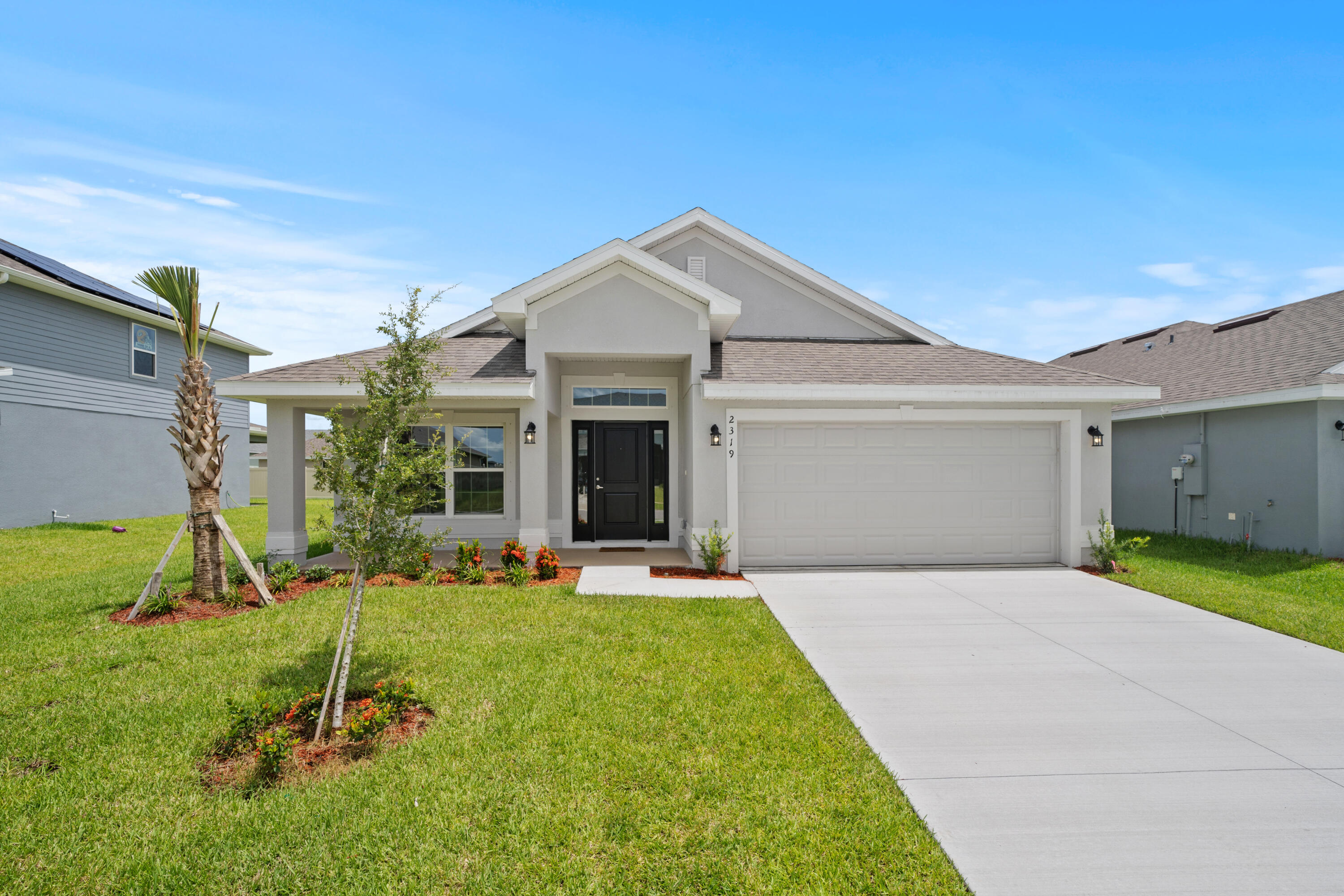 a view of a house with backyard and porch