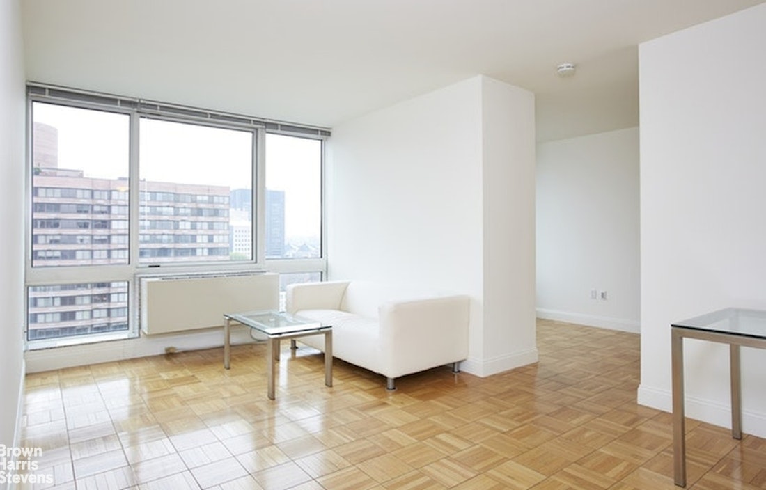 a living room with furniture and floor to ceiling window