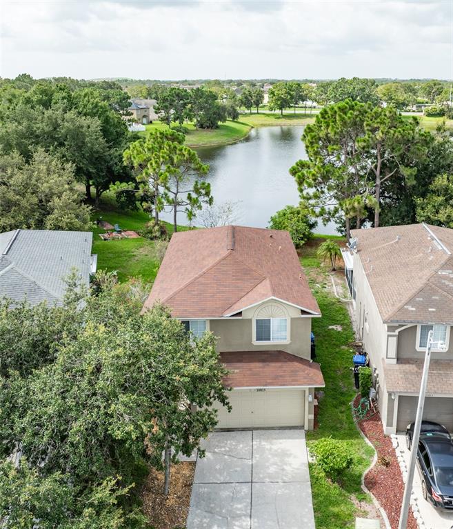 an aerial view of a house with a garden and lake view