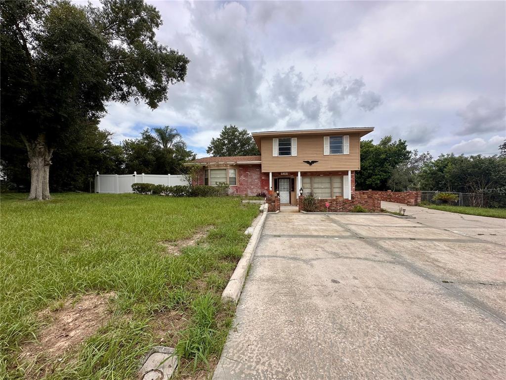 a view of house with a yard