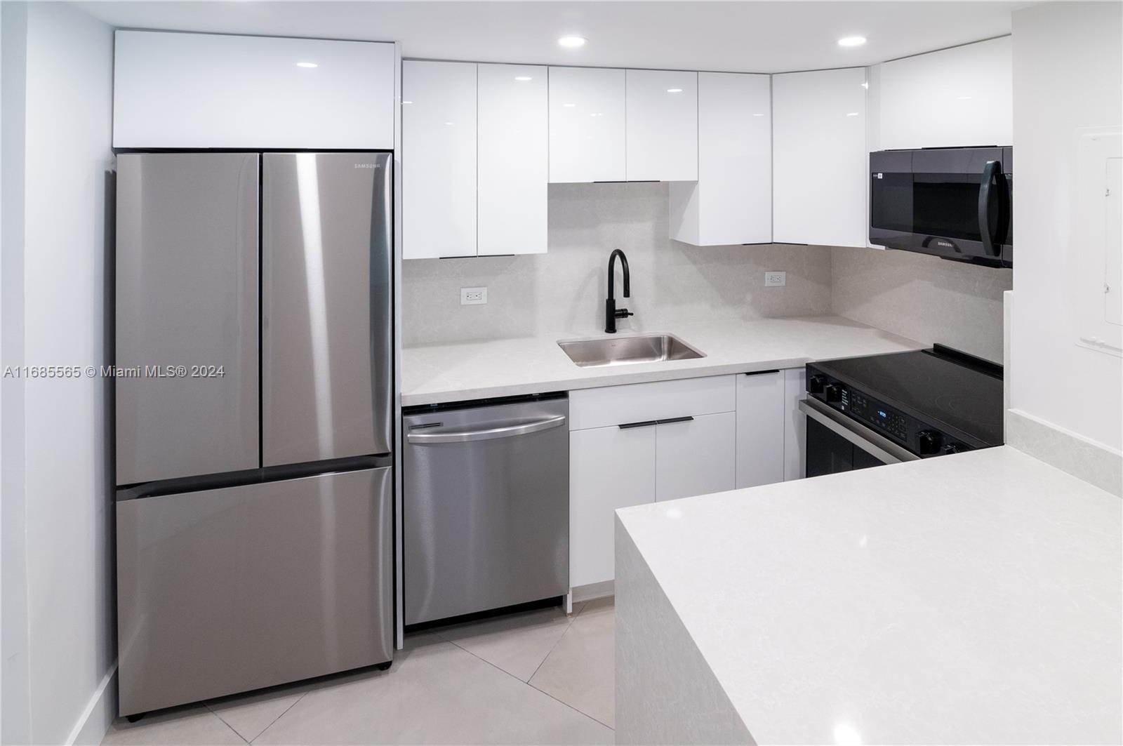 a kitchen with stainless steel appliances a refrigerator stove and microwave