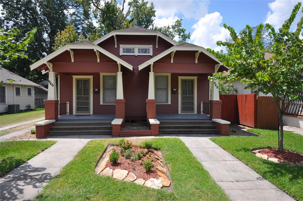 a front view of a house with yard and green space