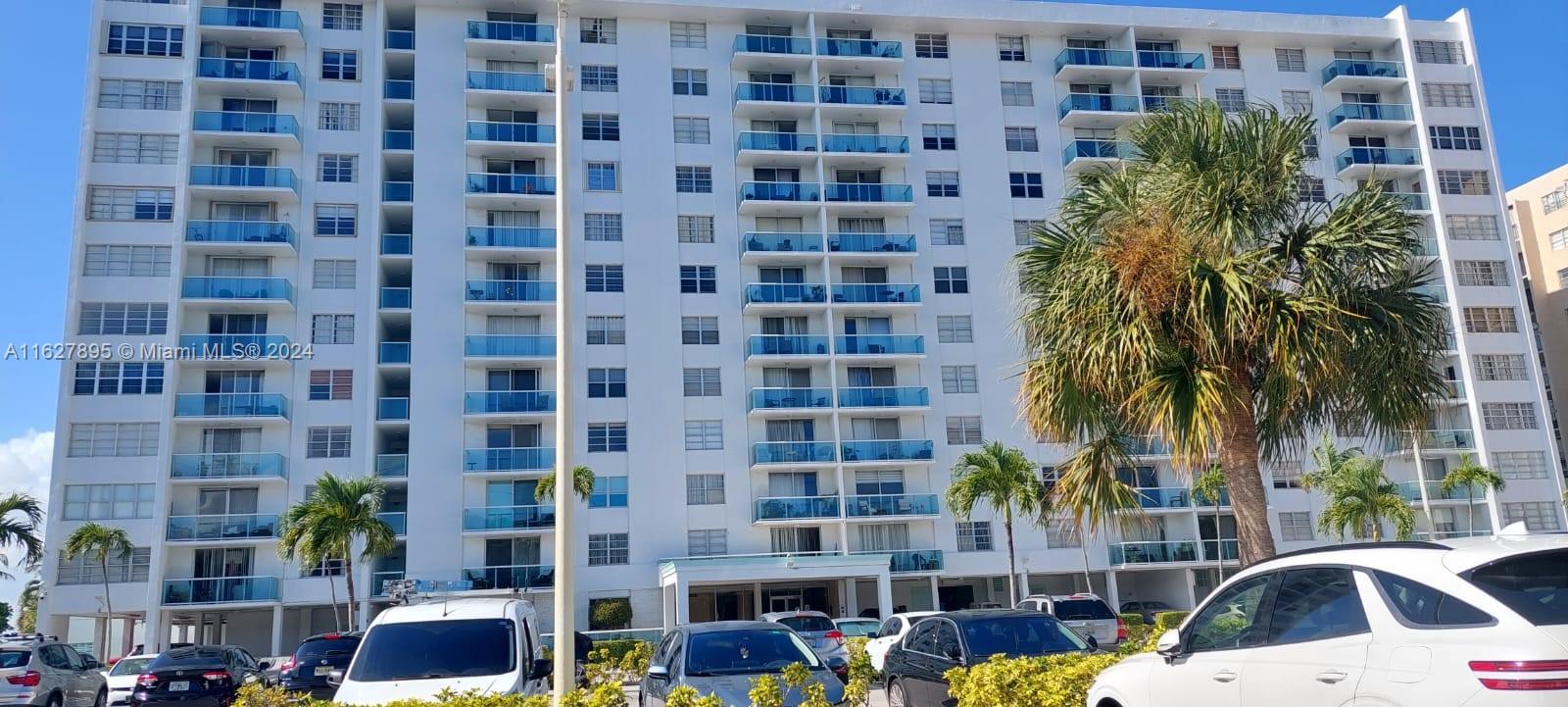 a view of a tall building next to a yard