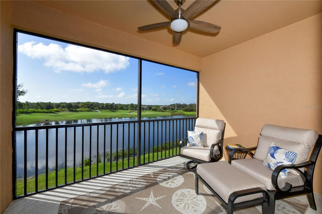 a view of a patio with a table chairs and a floor to ceiling window