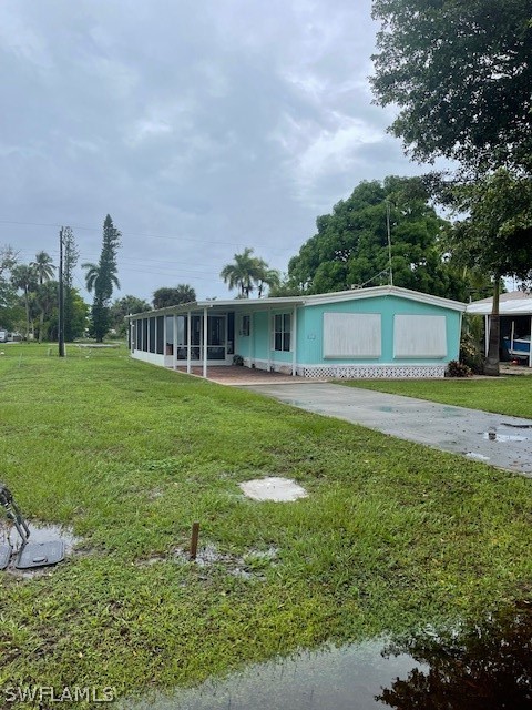 a view of a house with a yard and sitting area