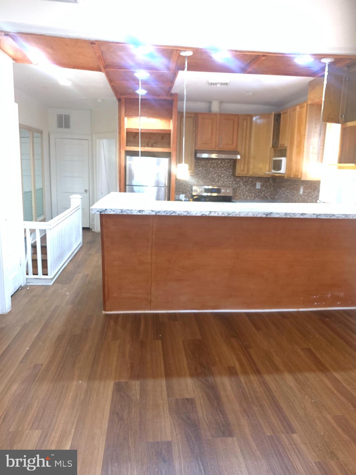 a view of kitchen and kitchen with furniture wooden floor and window