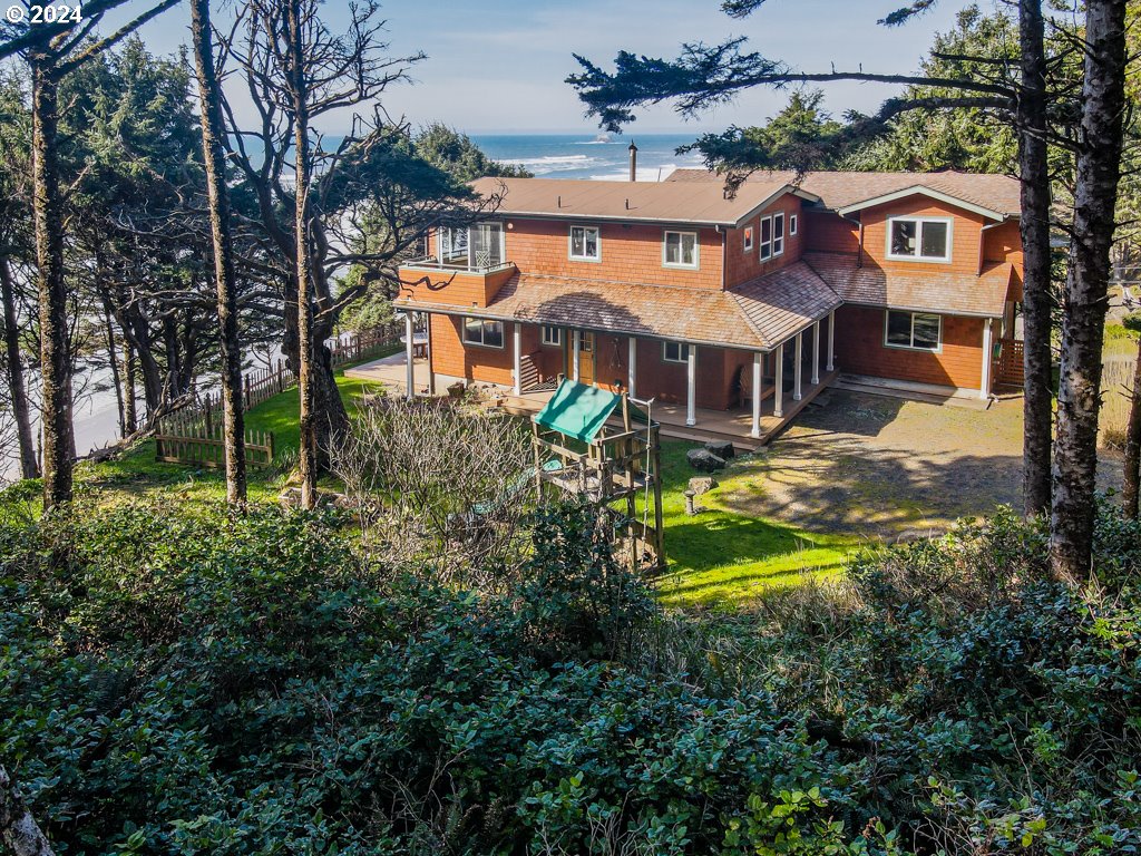 an aerial view of a house with a yard table and chairs