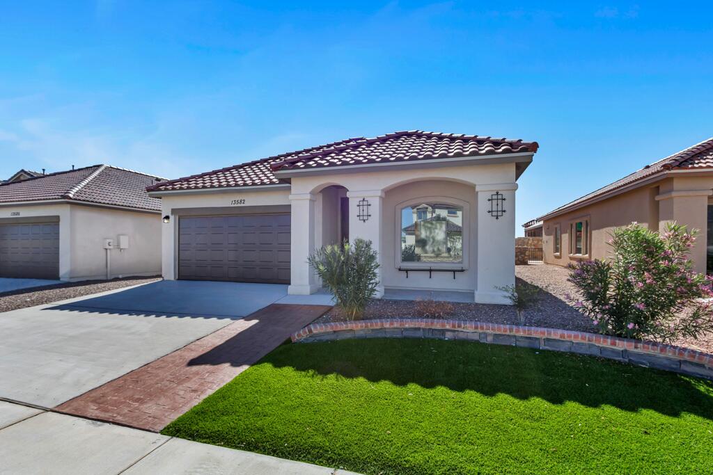 a front view of a house with a yard and garage