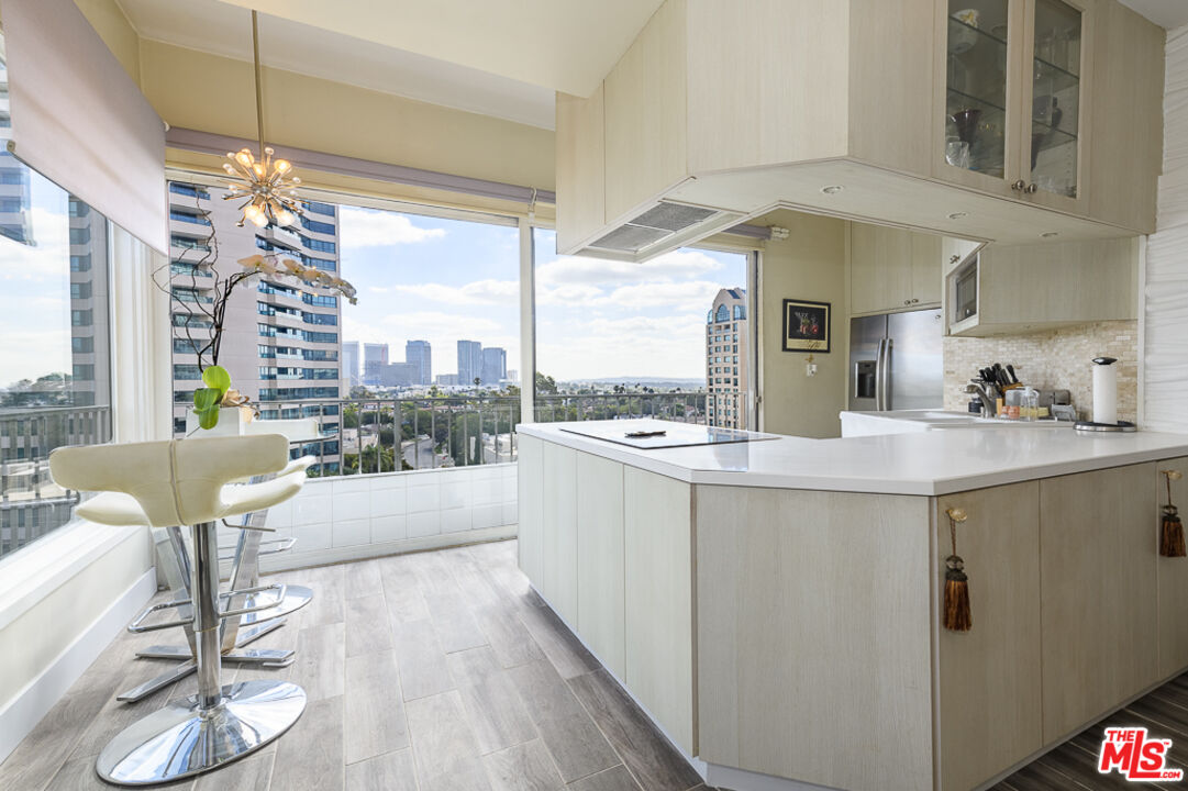 a kitchen with counter top a sink and cabinets