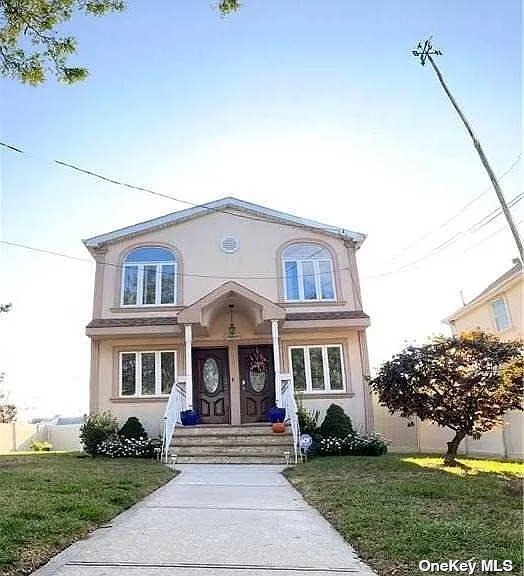 a front view of a house with a yard