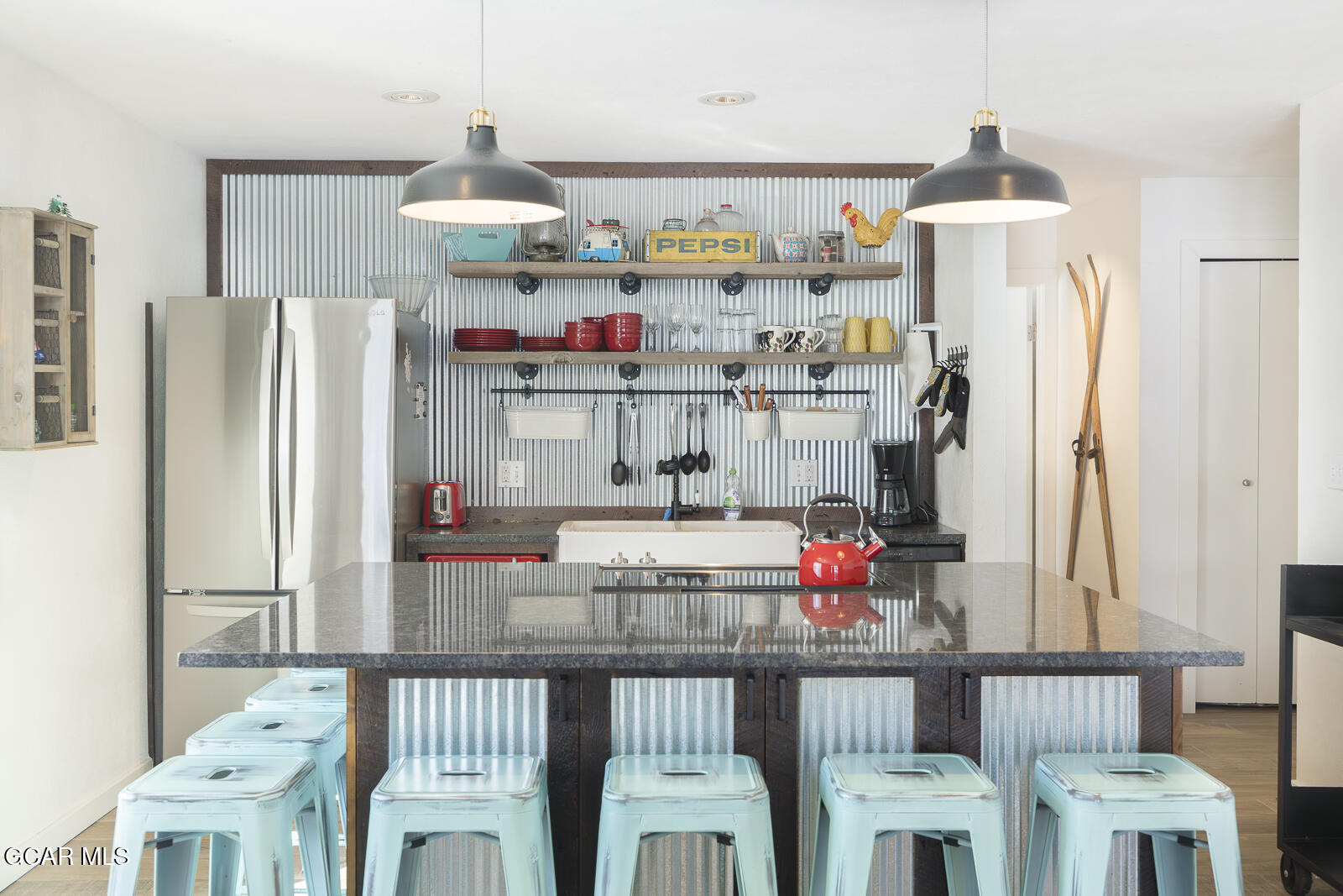 a kitchen with stainless steel appliances granite countertop a refrigerator and a stove