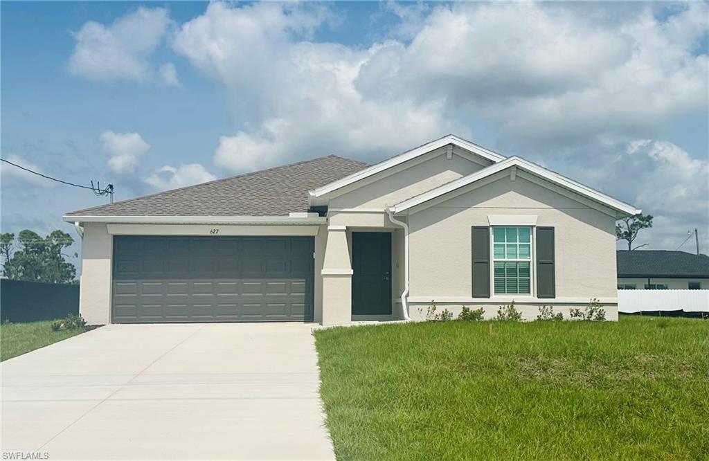 a front view of house with yard and green space