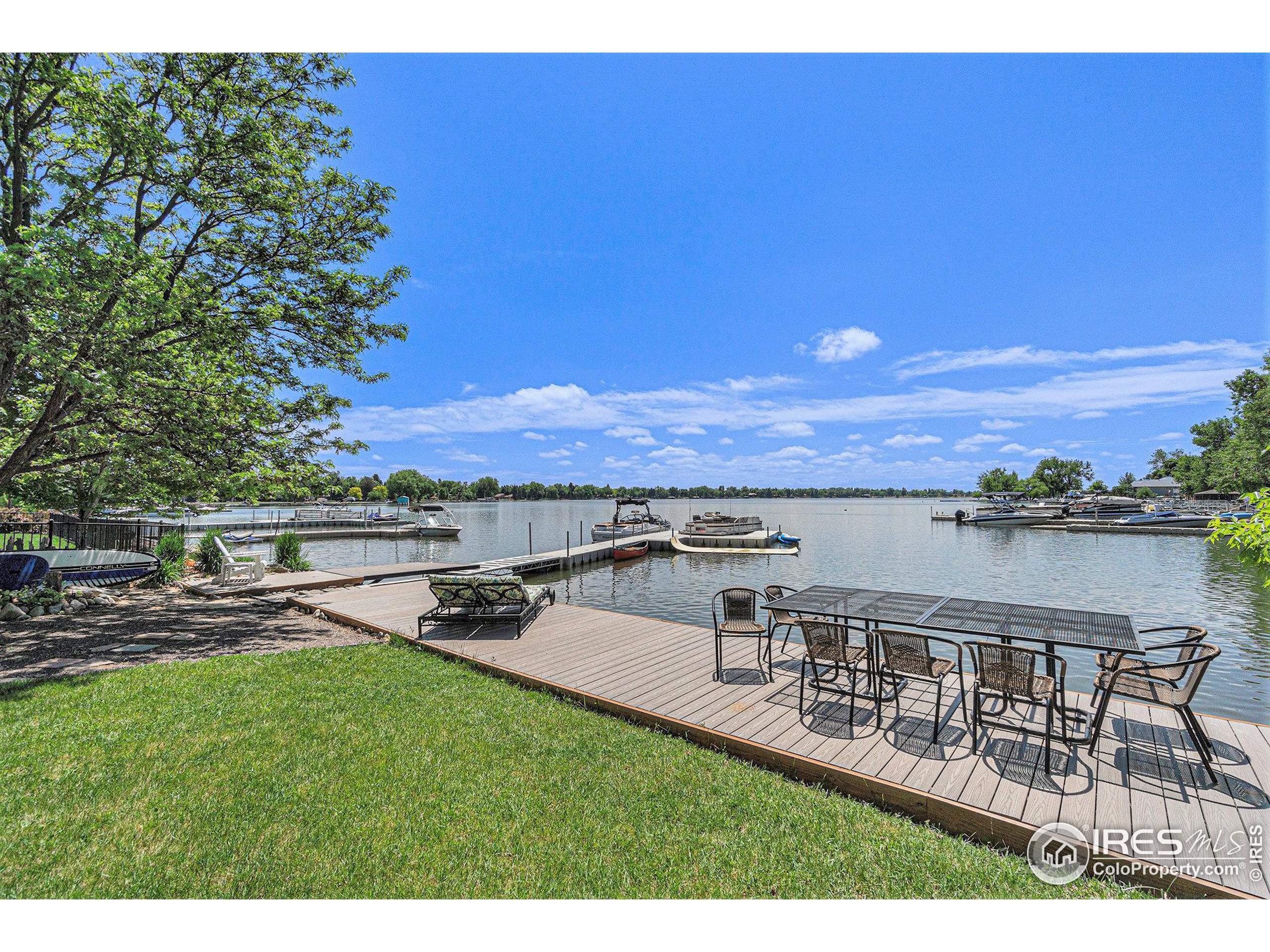 a view of a lake with couches and city view