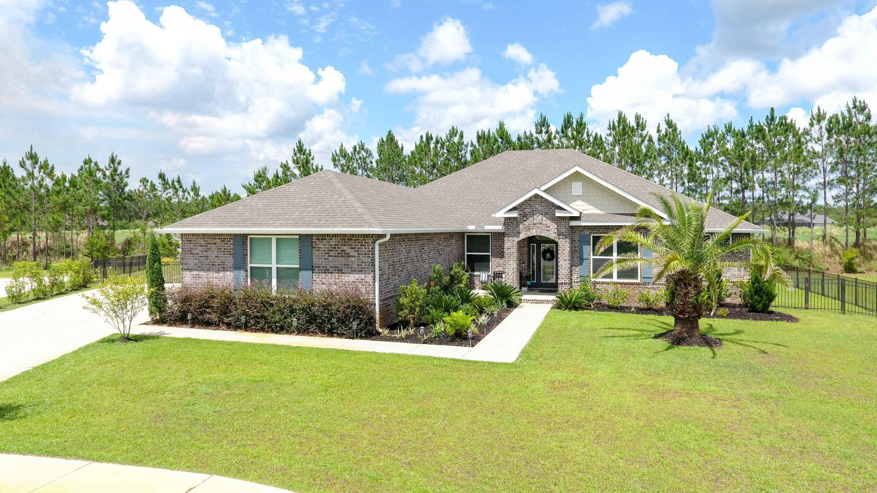 a front view of house with yard and green space