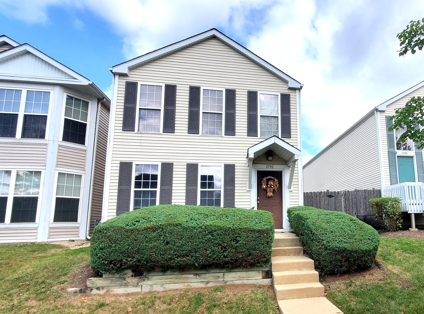 a front view of a house with a yard