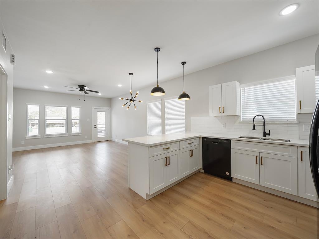 From the kitchen area, you can fully appreciate the open layout that seamlessly connects the living room and kitchen. This expansive view highlights the flow of the space, where the modern kitchen overlooks the living area, creating a cohesive and inviting environment ideal for both cooking and entertaining.