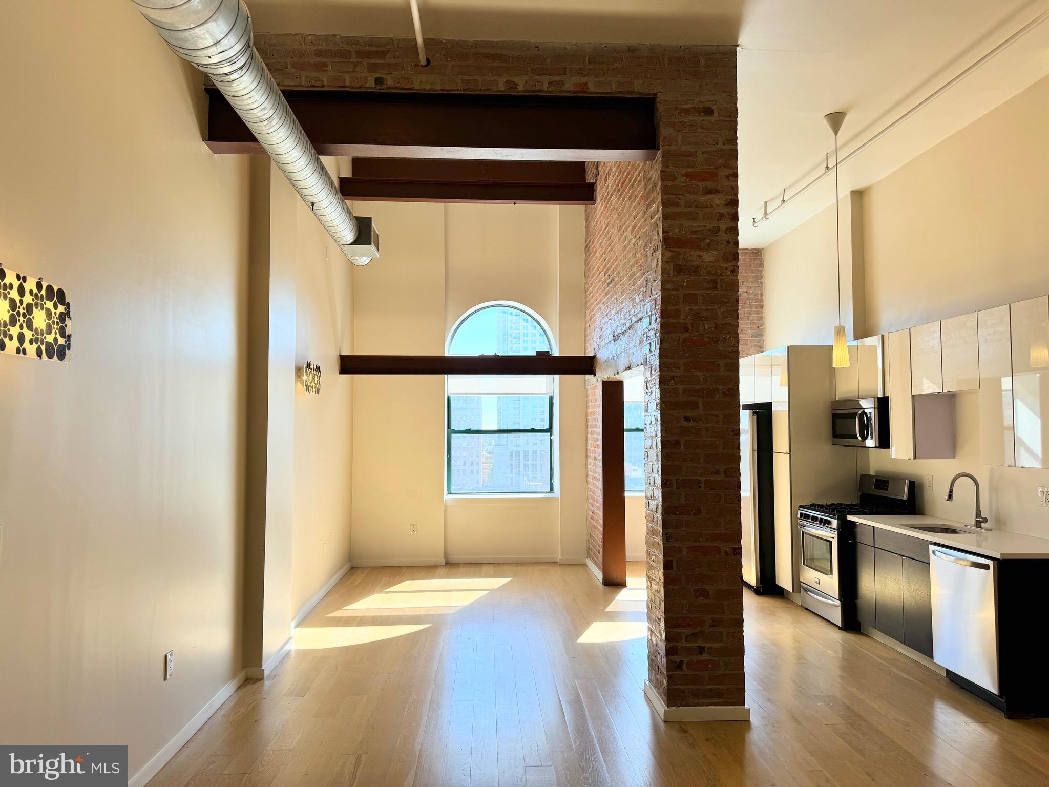 a view of a hallway with wooden floor and dining room