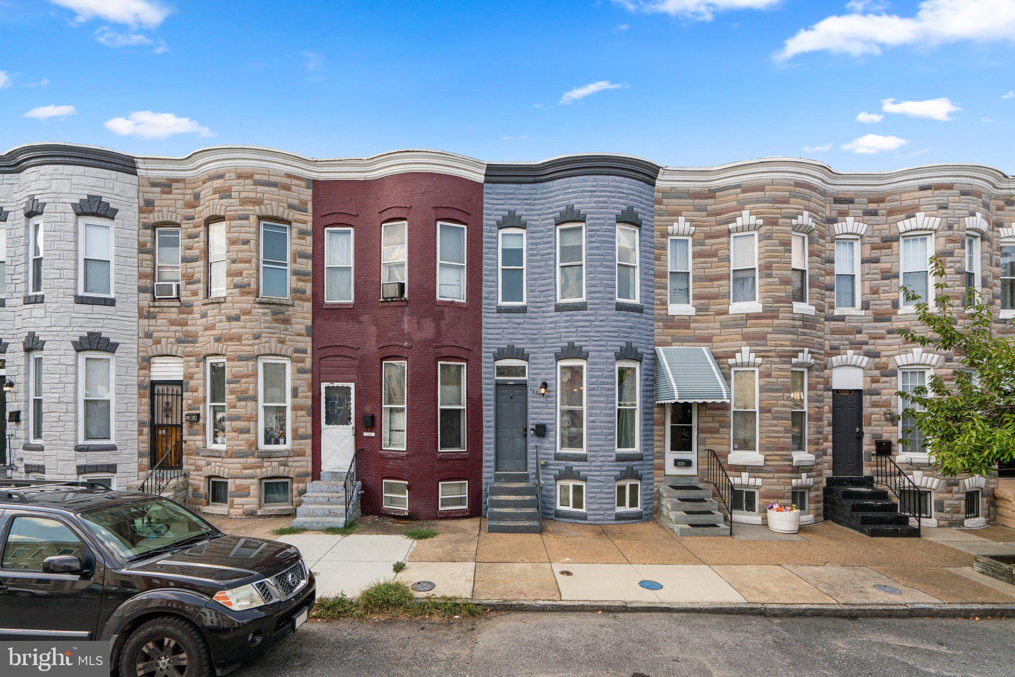 a front view of a residential apartment building with a yard