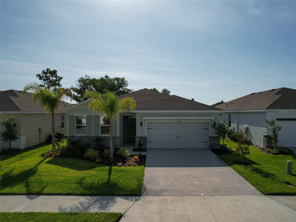 a front view of house with a garden