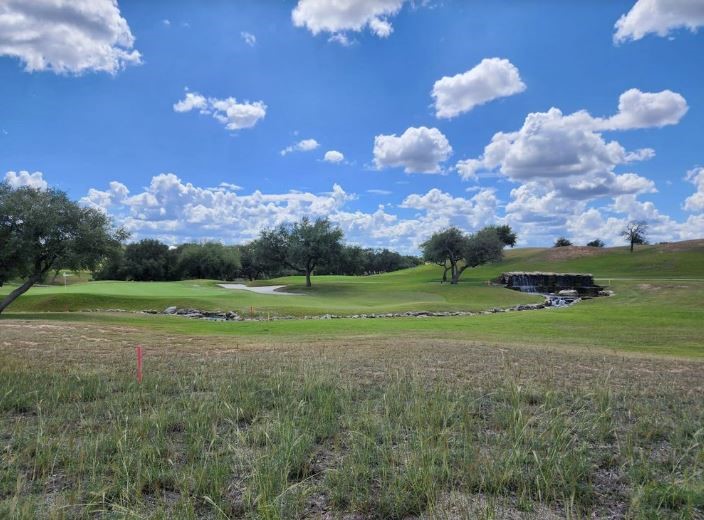 a view of a golf course with a big yard