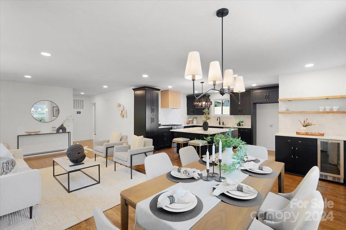 a dining room with furniture a table and kitchen view