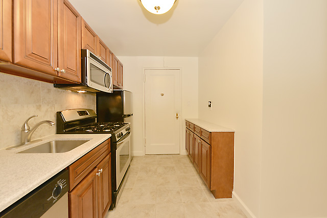 a kitchen with stainless steel appliances granite countertop a sink and a stove