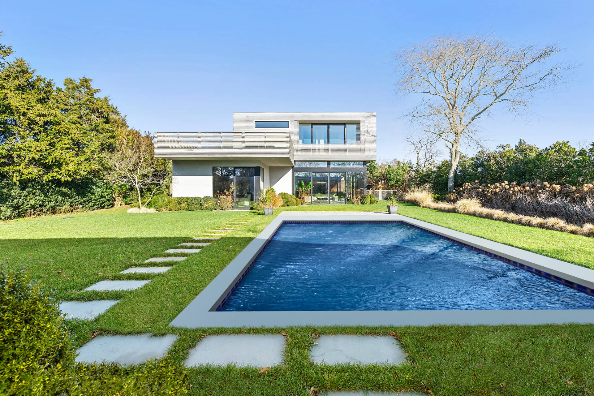 a view of yard with swimming pool and green space