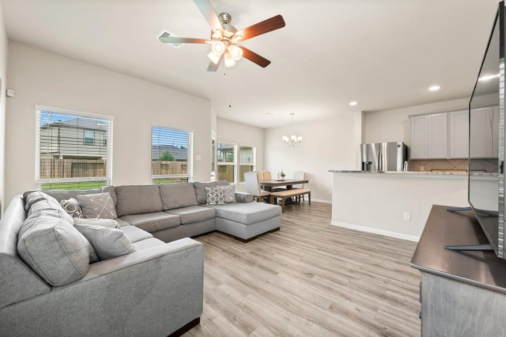 a living room with furniture and kitchen view