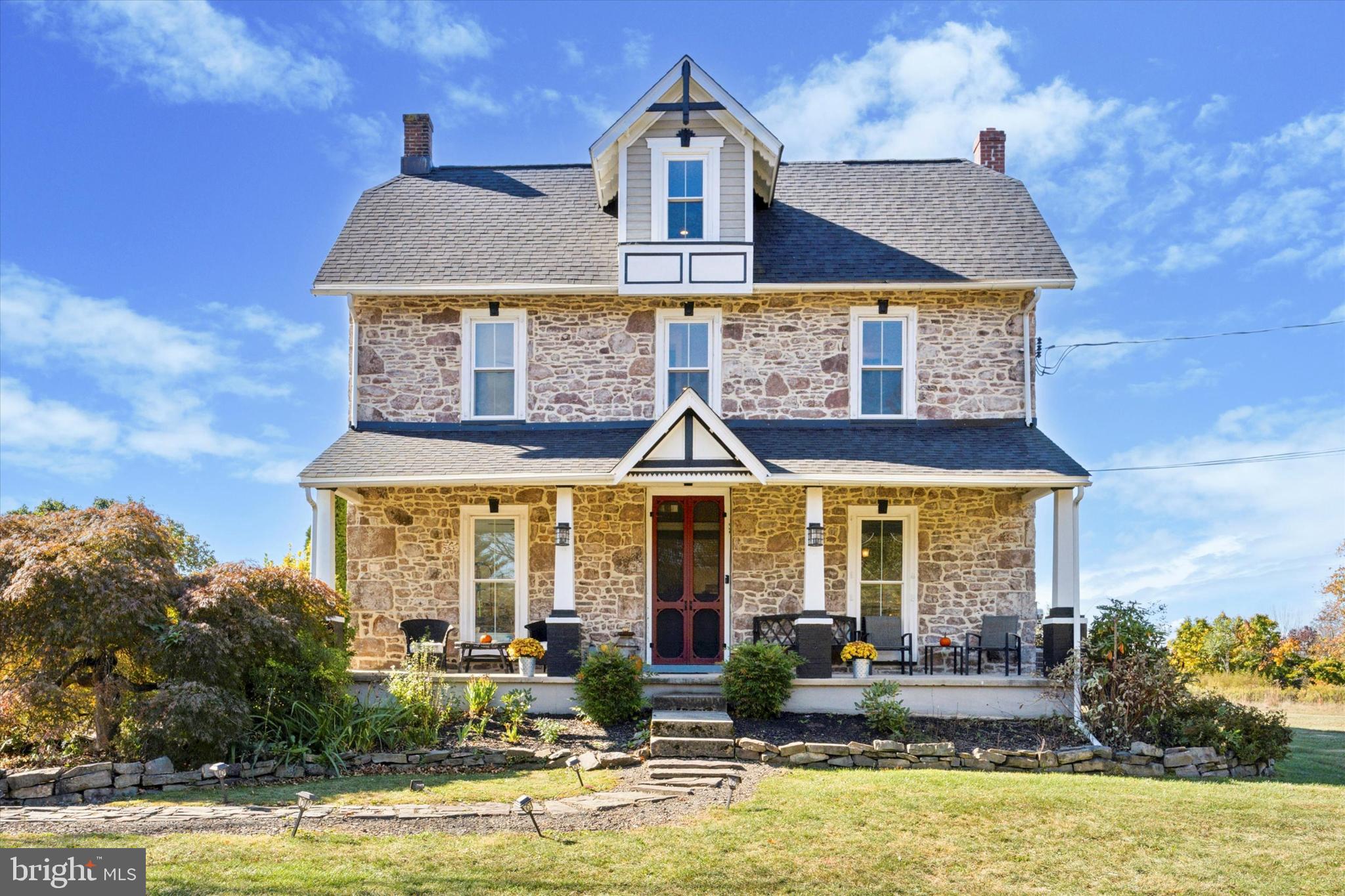 a front view of a house with swimming pool and furniture